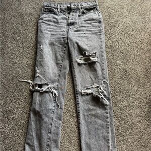 BDG faded black slim straight jeans with holes.